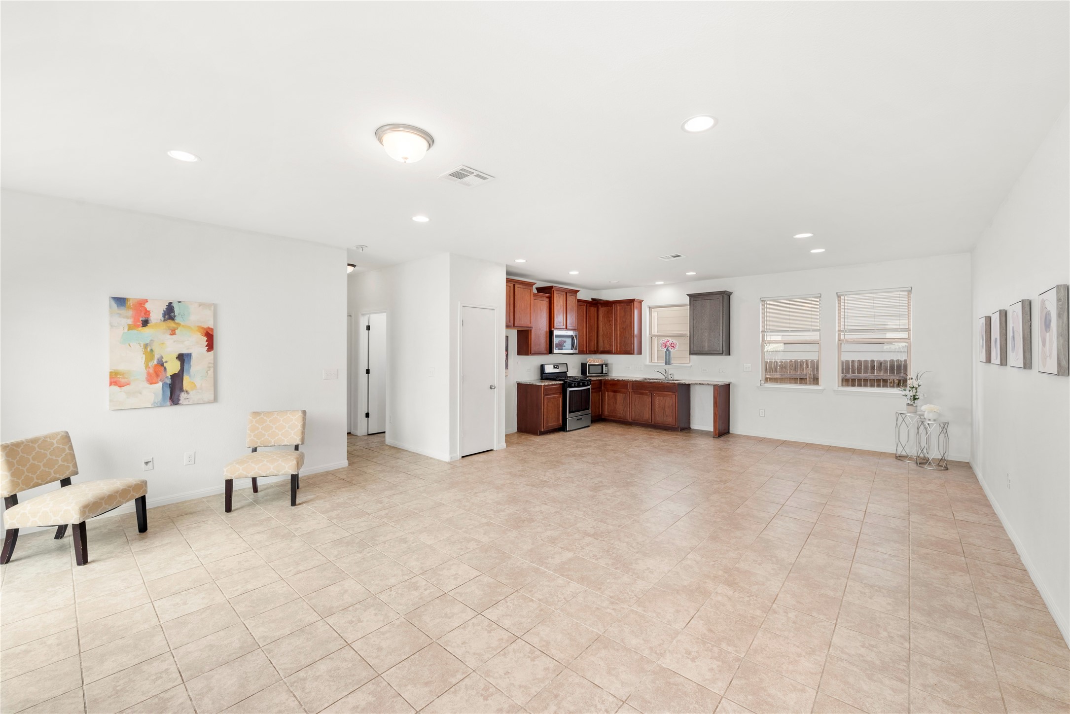 a living room with furniture and kitchen view