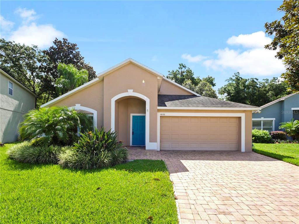 a front view of a house with a yard and garage