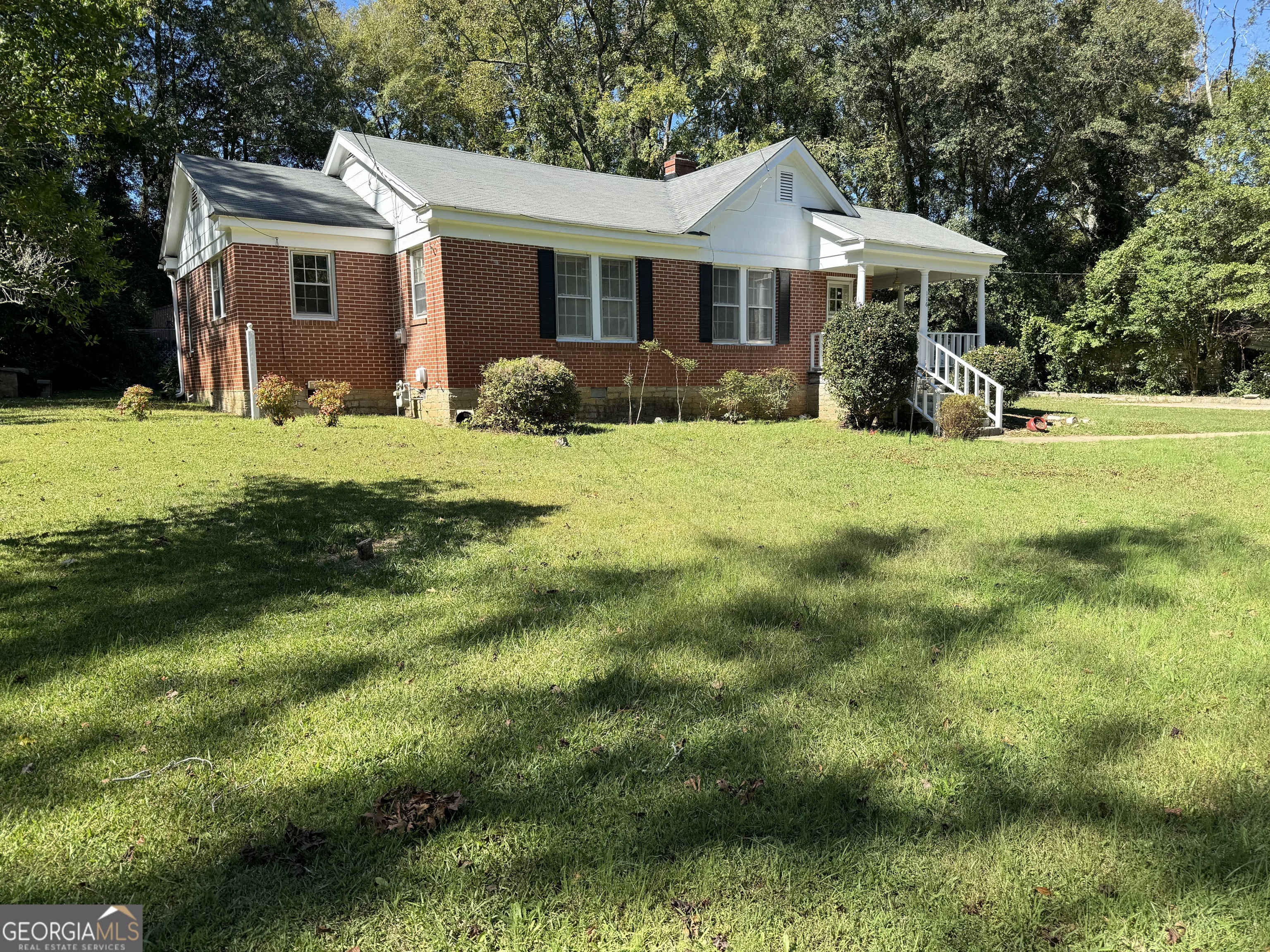 a front view of house with yard and green space