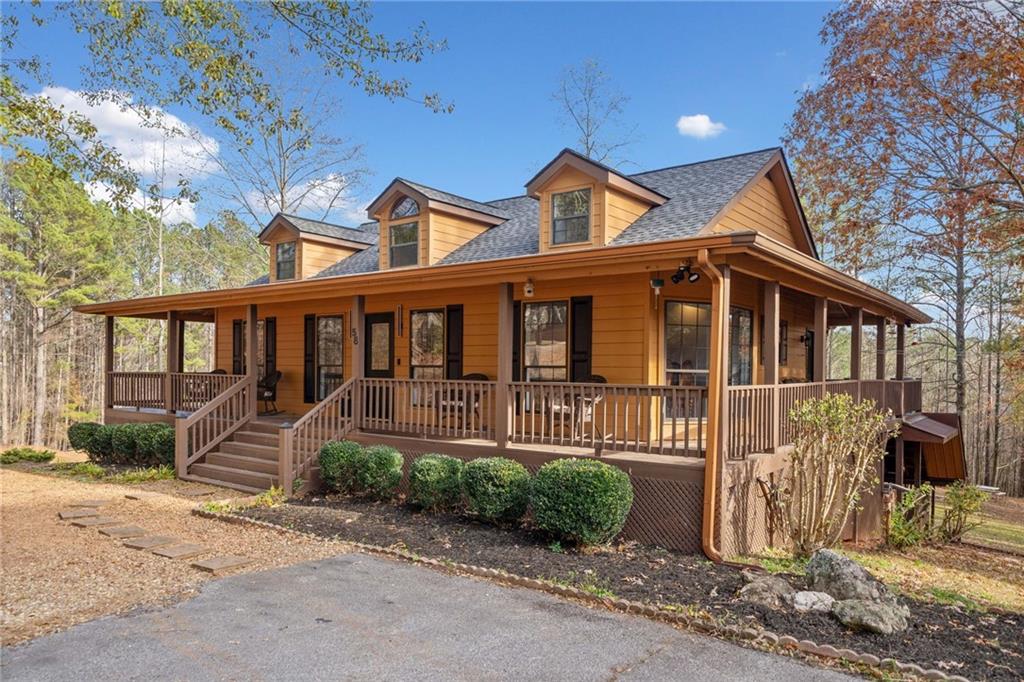 a front view of a house with a yard and outdoor seating