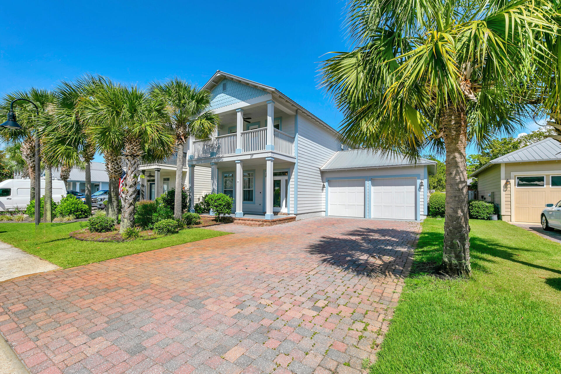 a front view of a house with a yard and trees