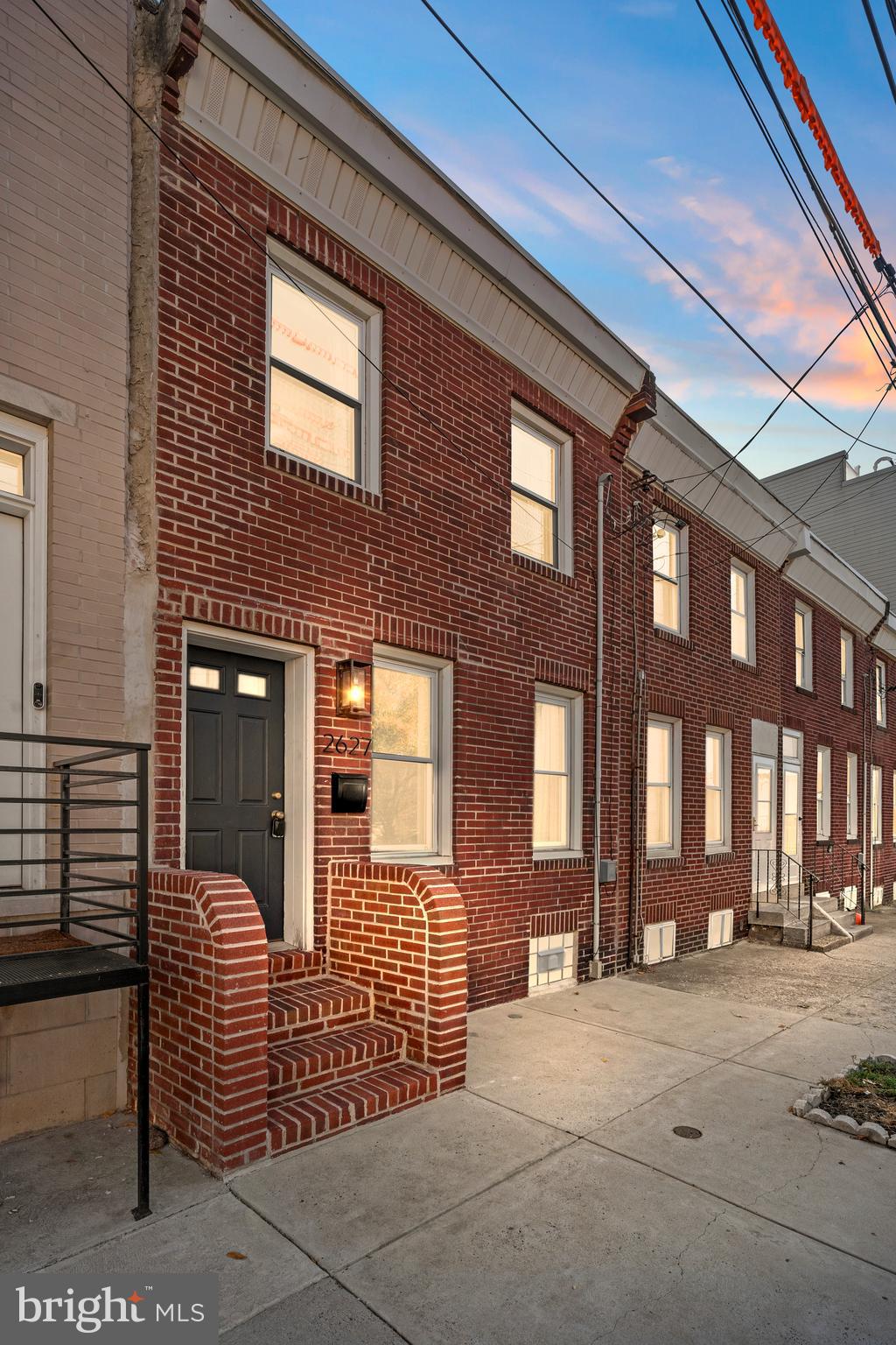 a couple of chairs in front of brick building