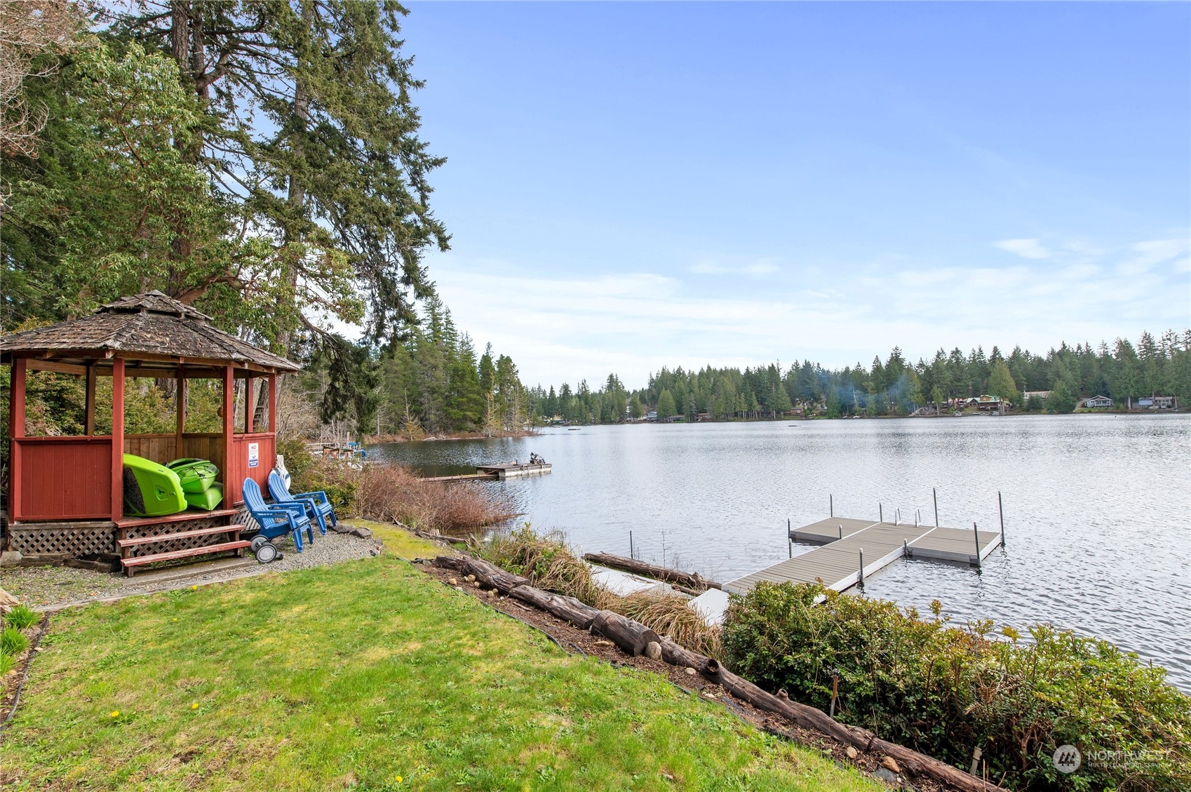 a view of a lake with a yard and potted plants