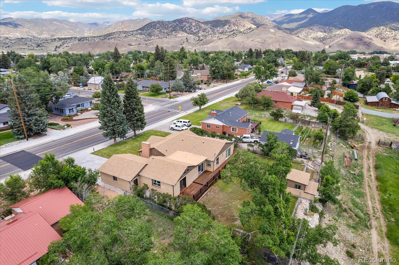 an aerial view of a city with lots of residential buildings ocean and mountain view in back