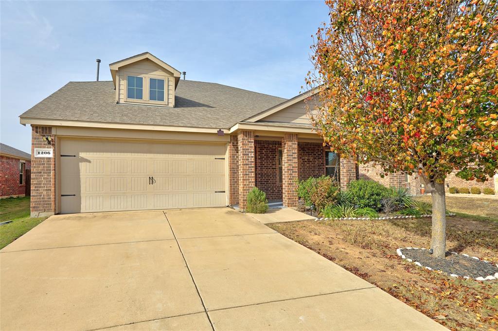 View of front facade featuring a garage