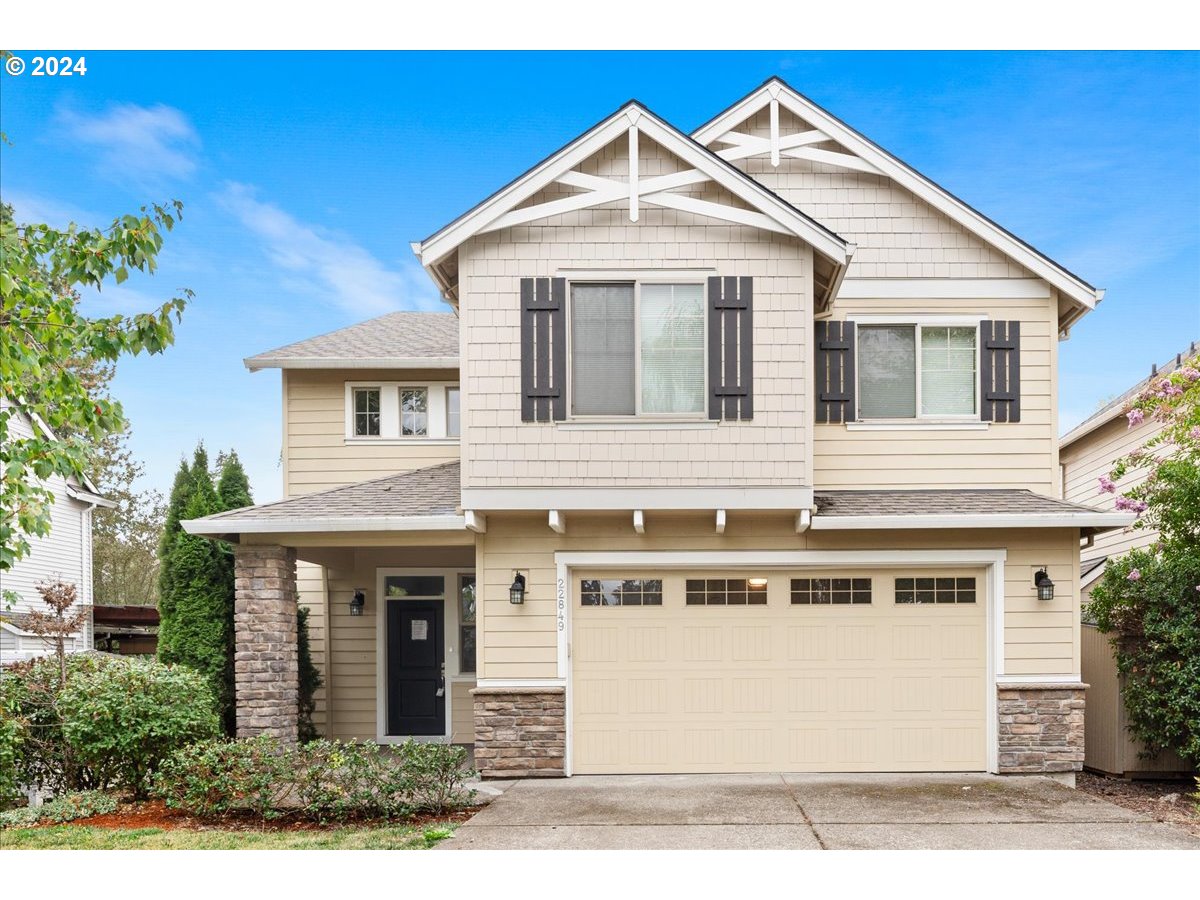 a front view of a house with a yard and garage