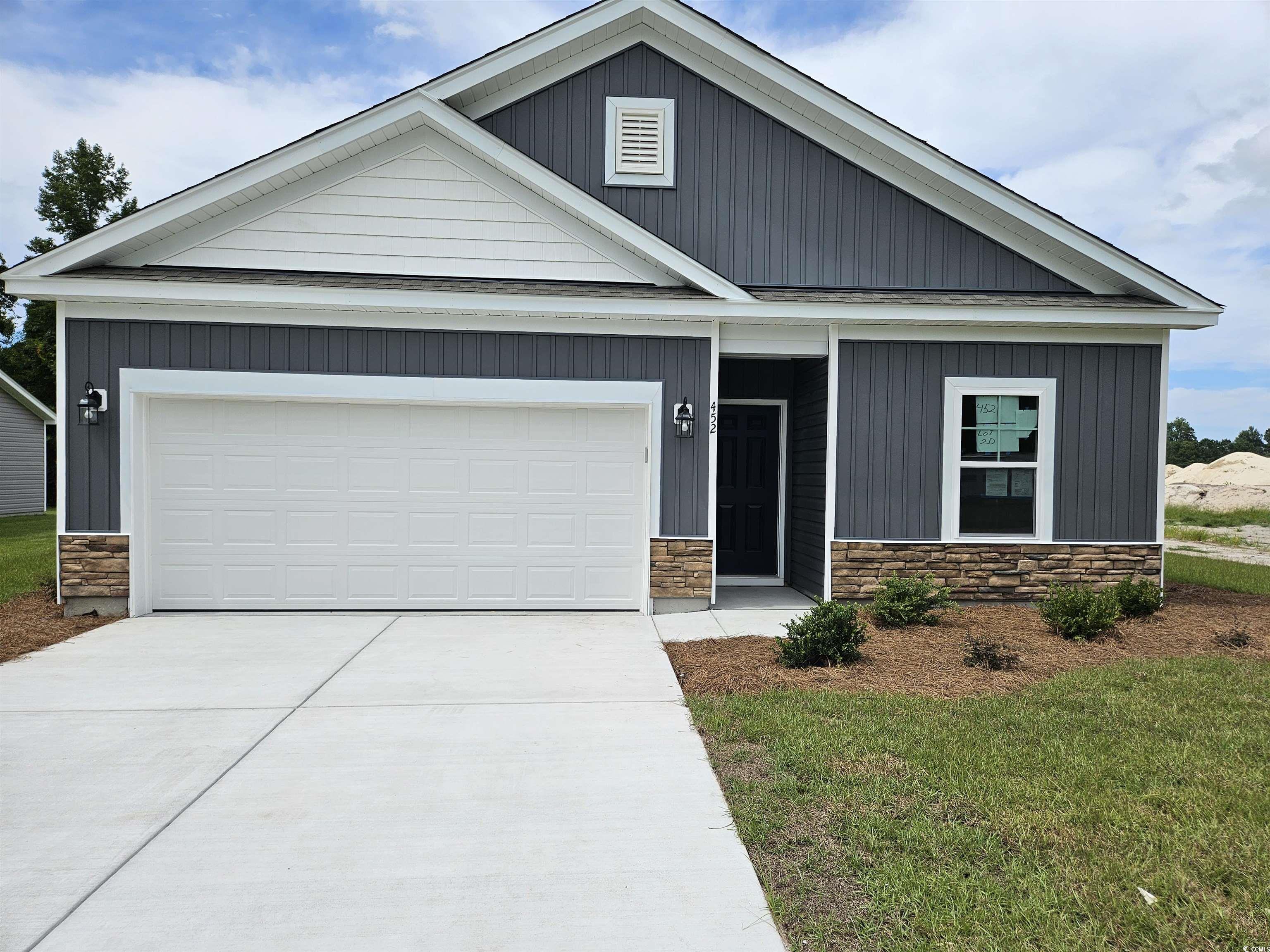 View of front of home featuring a garage, covered