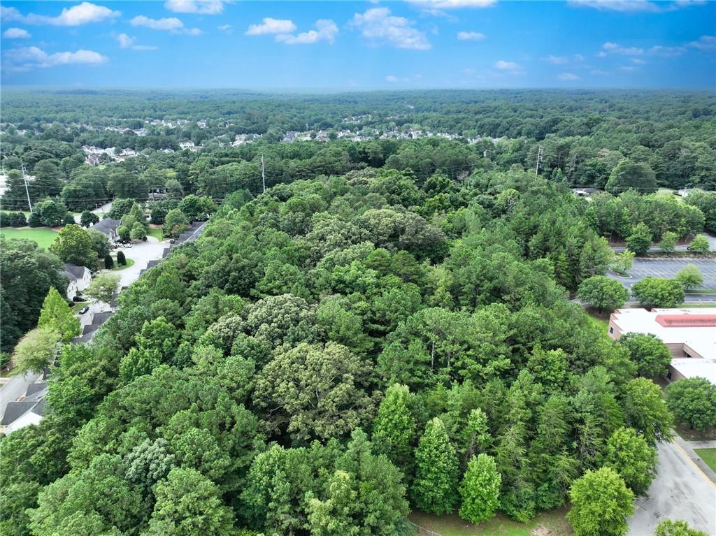 an aerial view of a houses with a yard