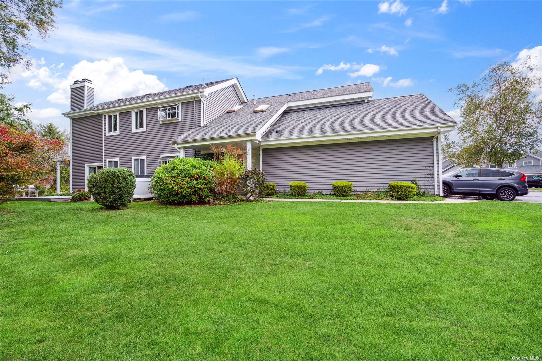 a front view of a house with a garden