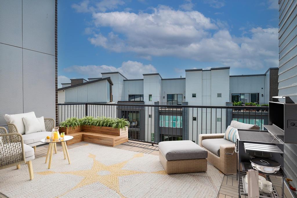 a balcony with furniture and a potted plant