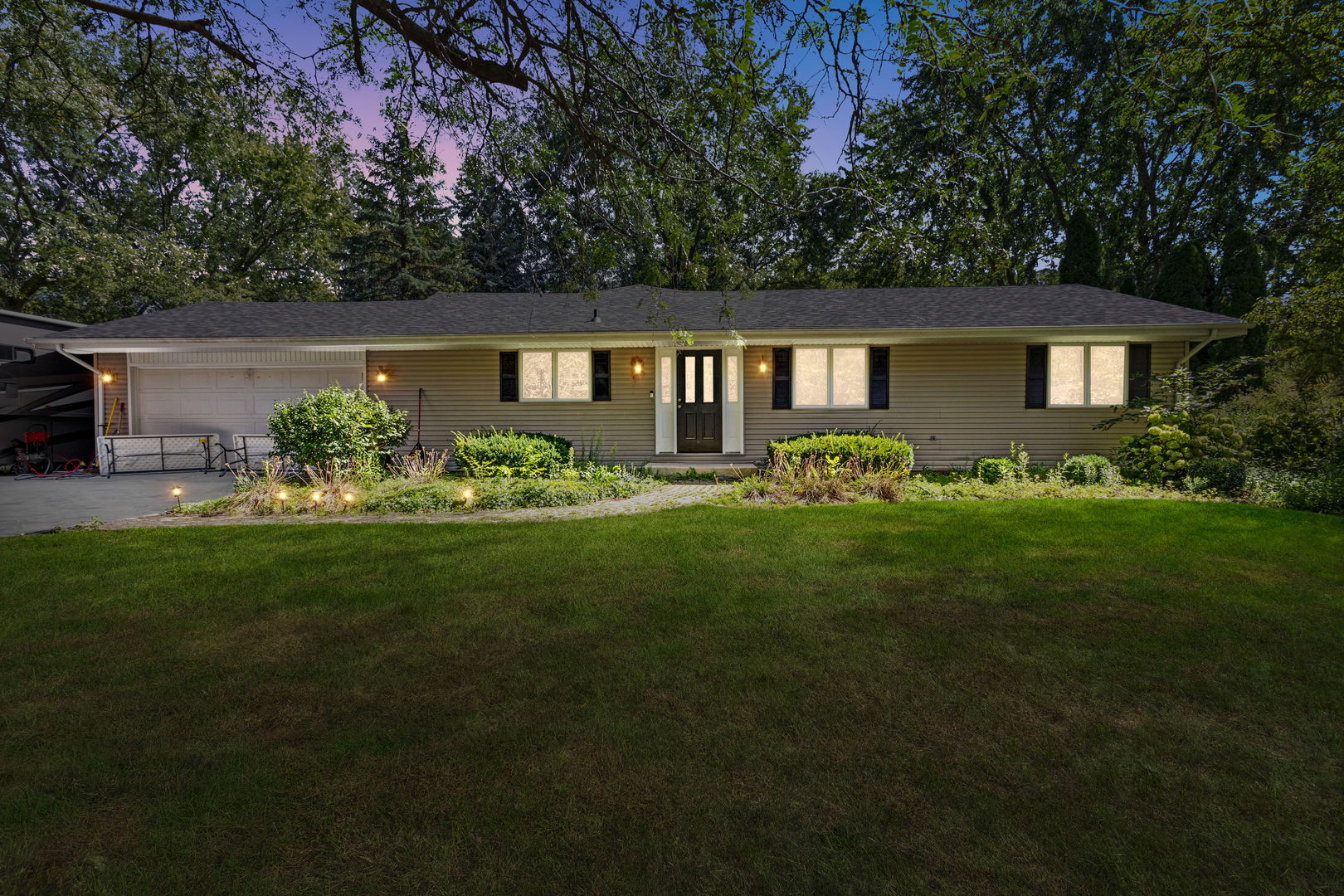 a front view of a house with a garden