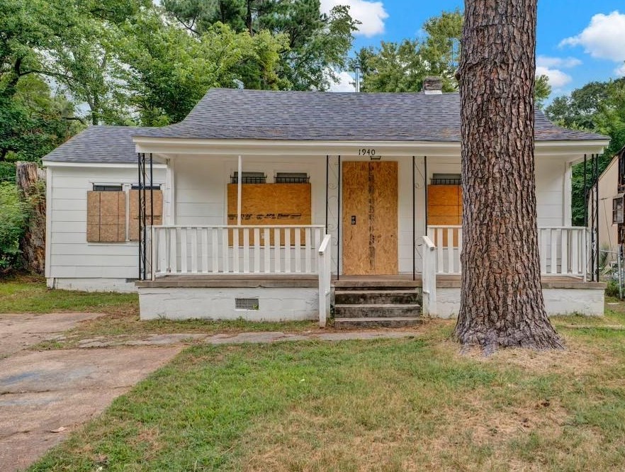 a view of a house with a yard and tree s