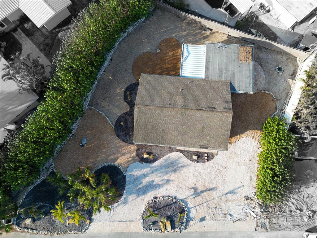 an aerial view of a house with a yard and a sitting area