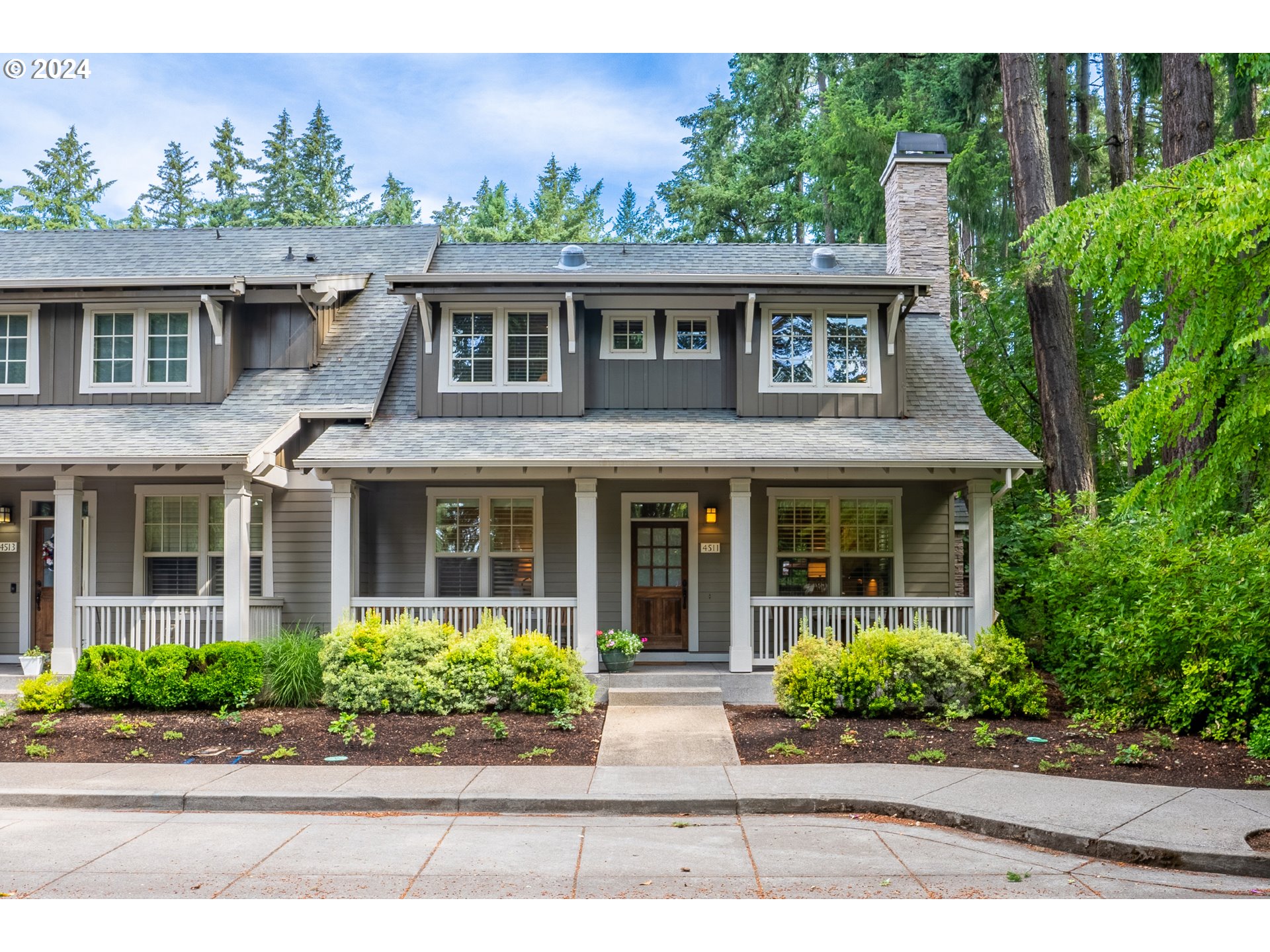 a front view of a house with a garden