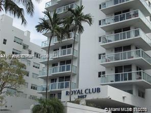 a front view of multi story residential apartment building with a yard