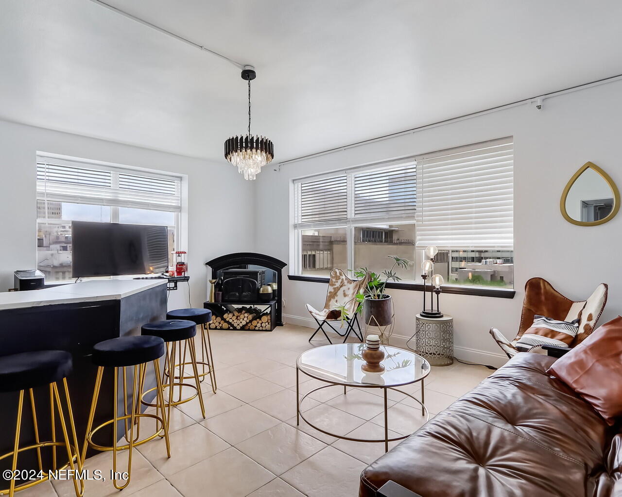 a living room with furniture a flat screen tv and a window