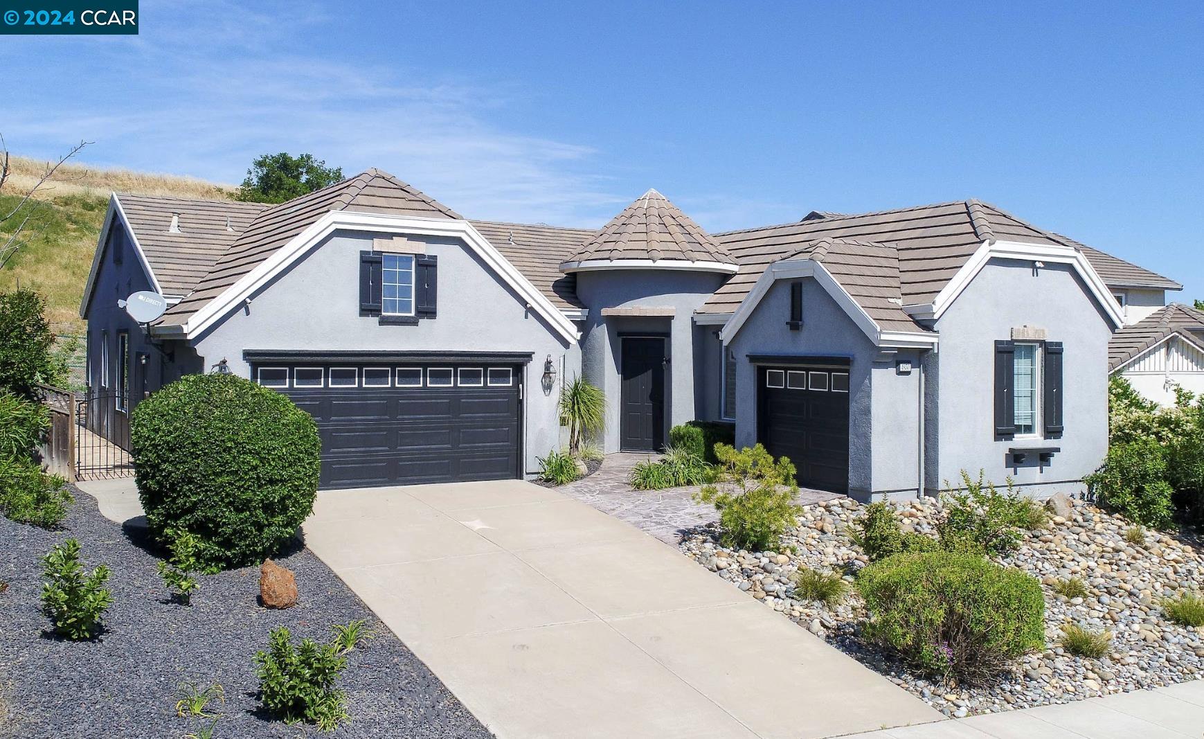 a front view of a house with a garden