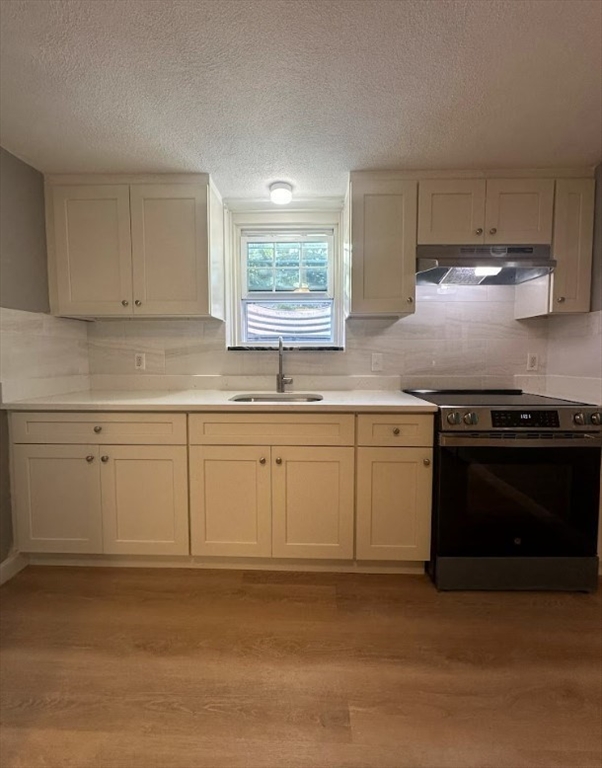 a kitchen with granite countertop white cabinets and stainless steel appliances