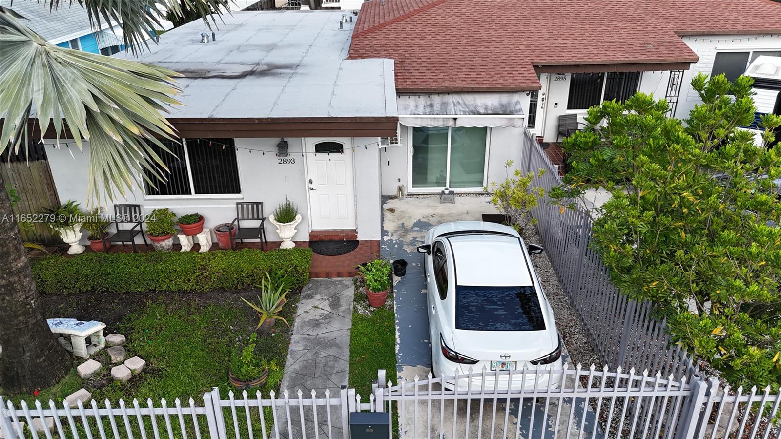 a front view of a house with a garden