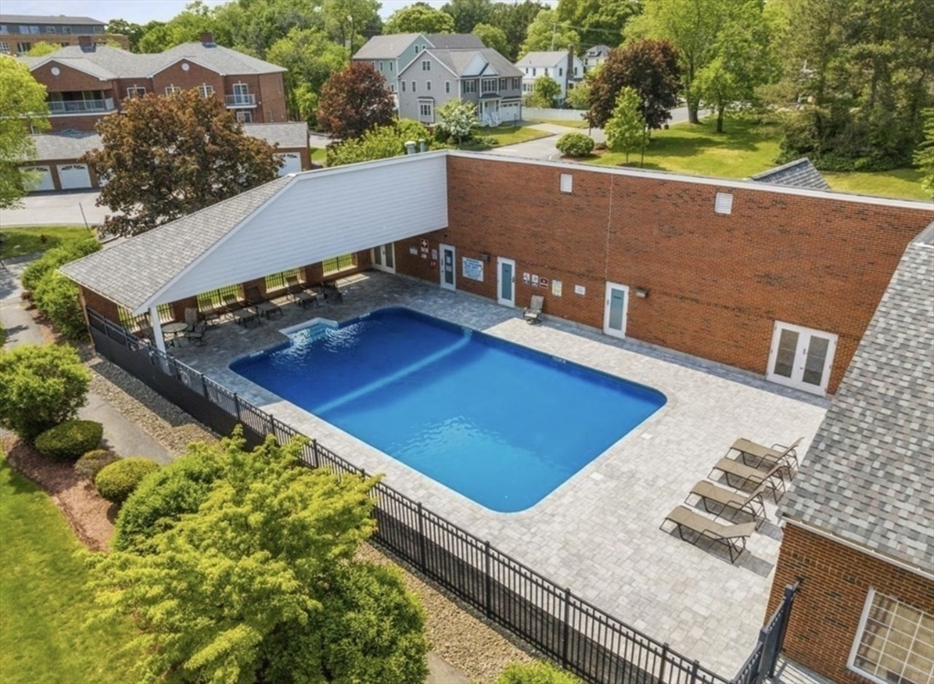 an aerial view of a house with a swimming pool