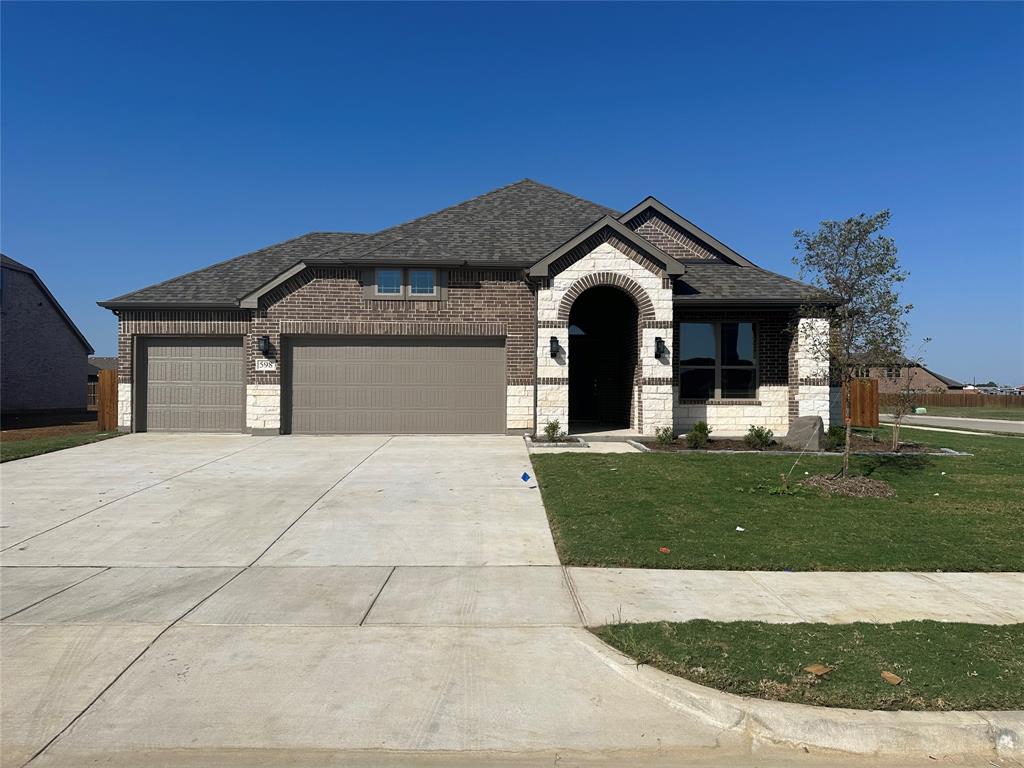 a front view of a house with a yard