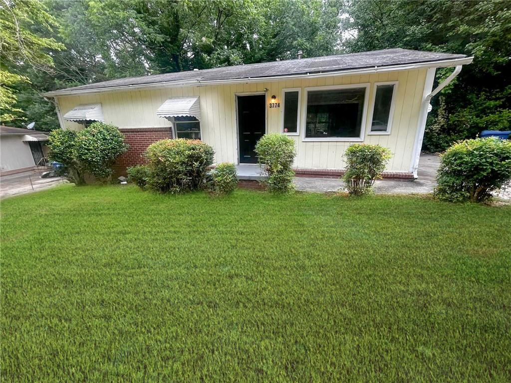 a front view of house with yard and green space