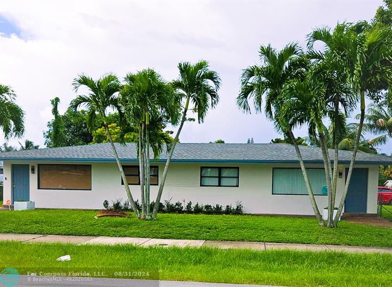 a front view of a house with a garden and yard