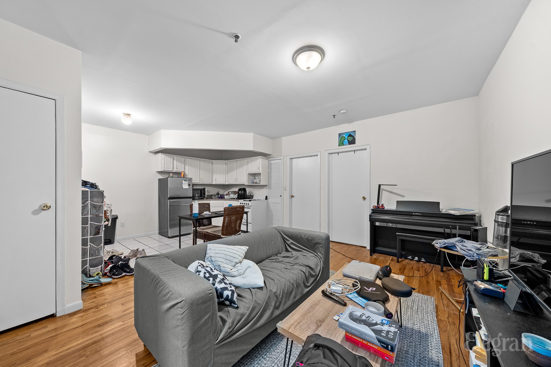 a living room with furniture and a wooden floor