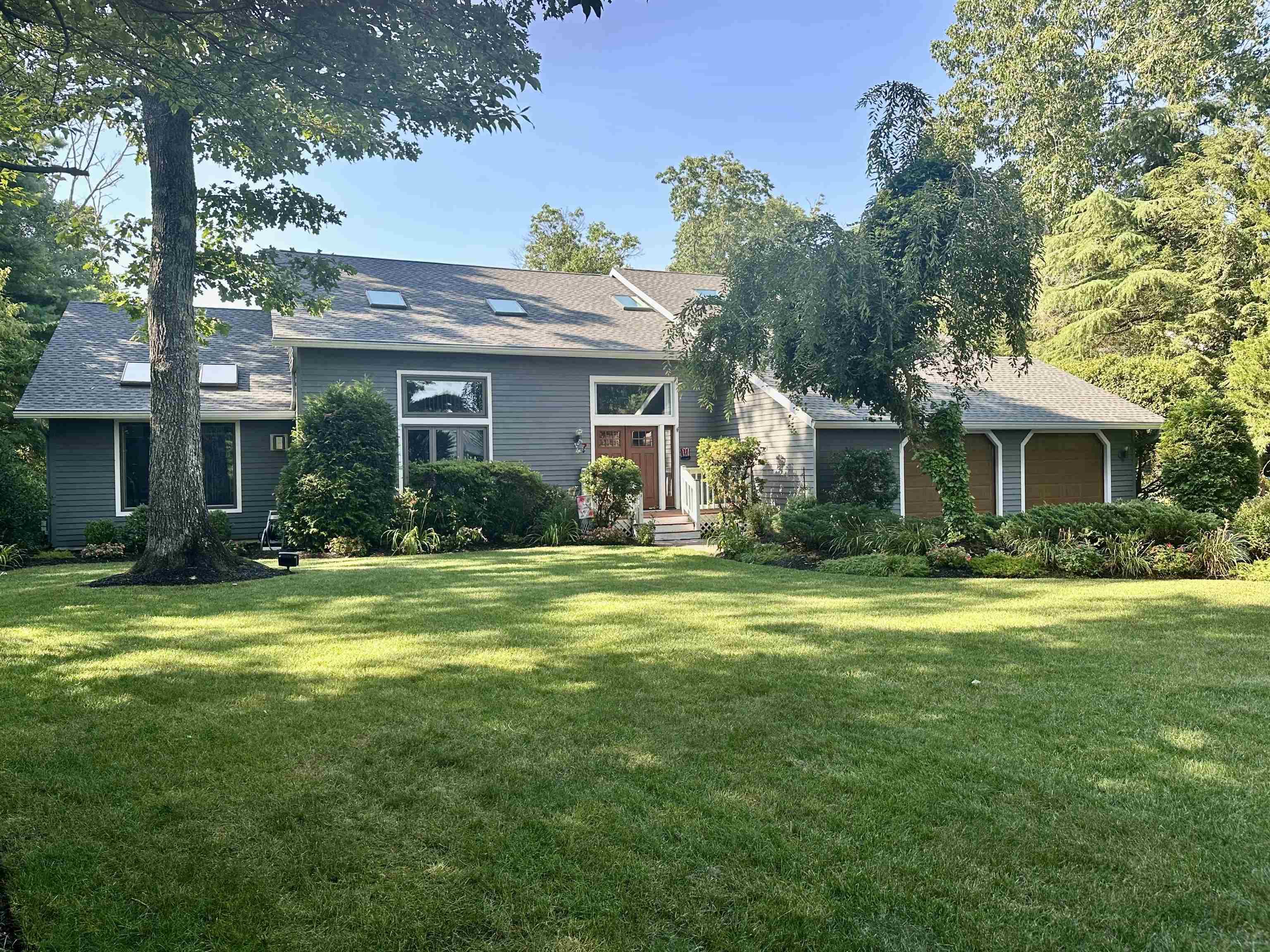 a front view of a house with a garden