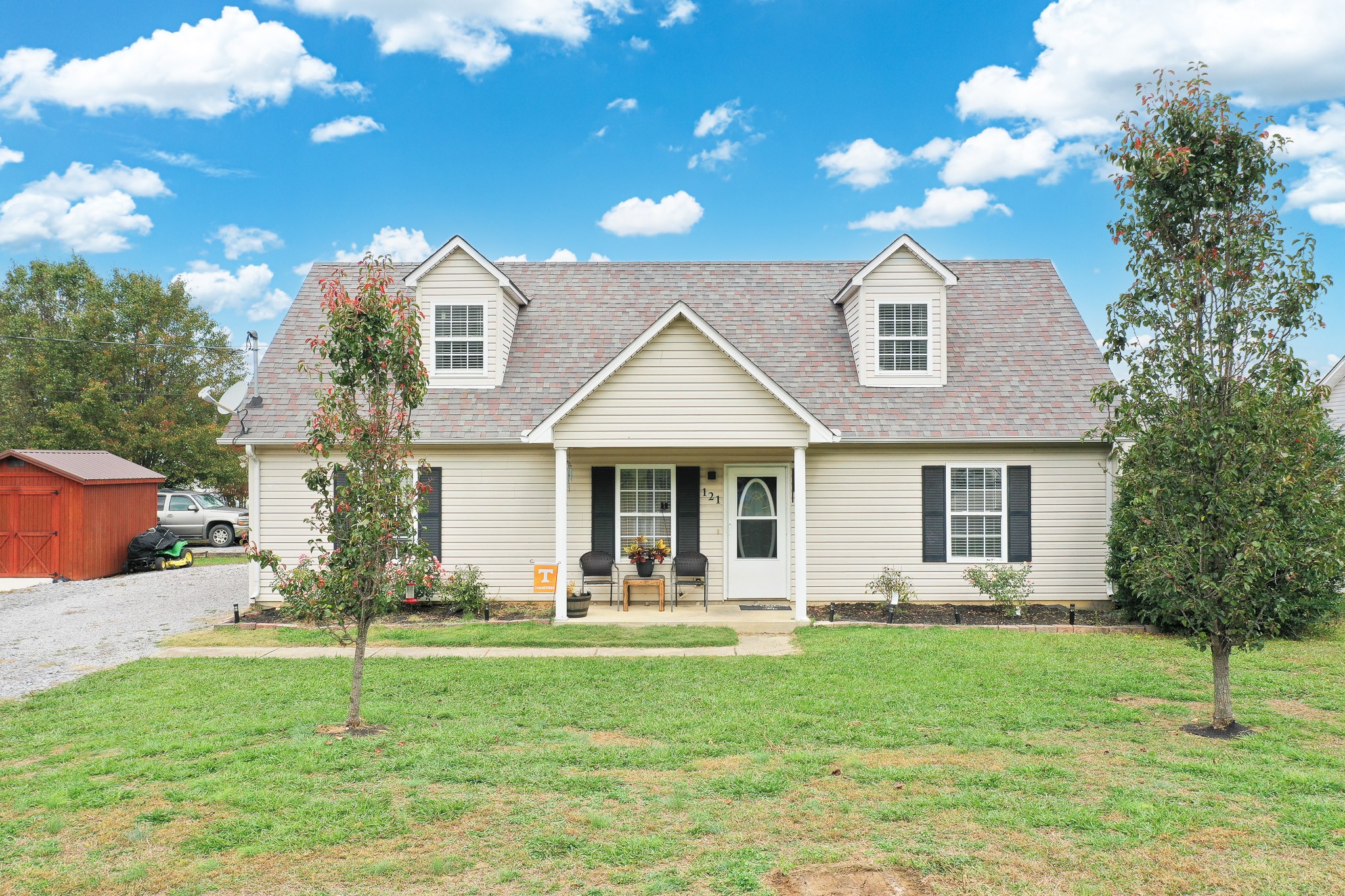 a front view of a house with a yard and garage