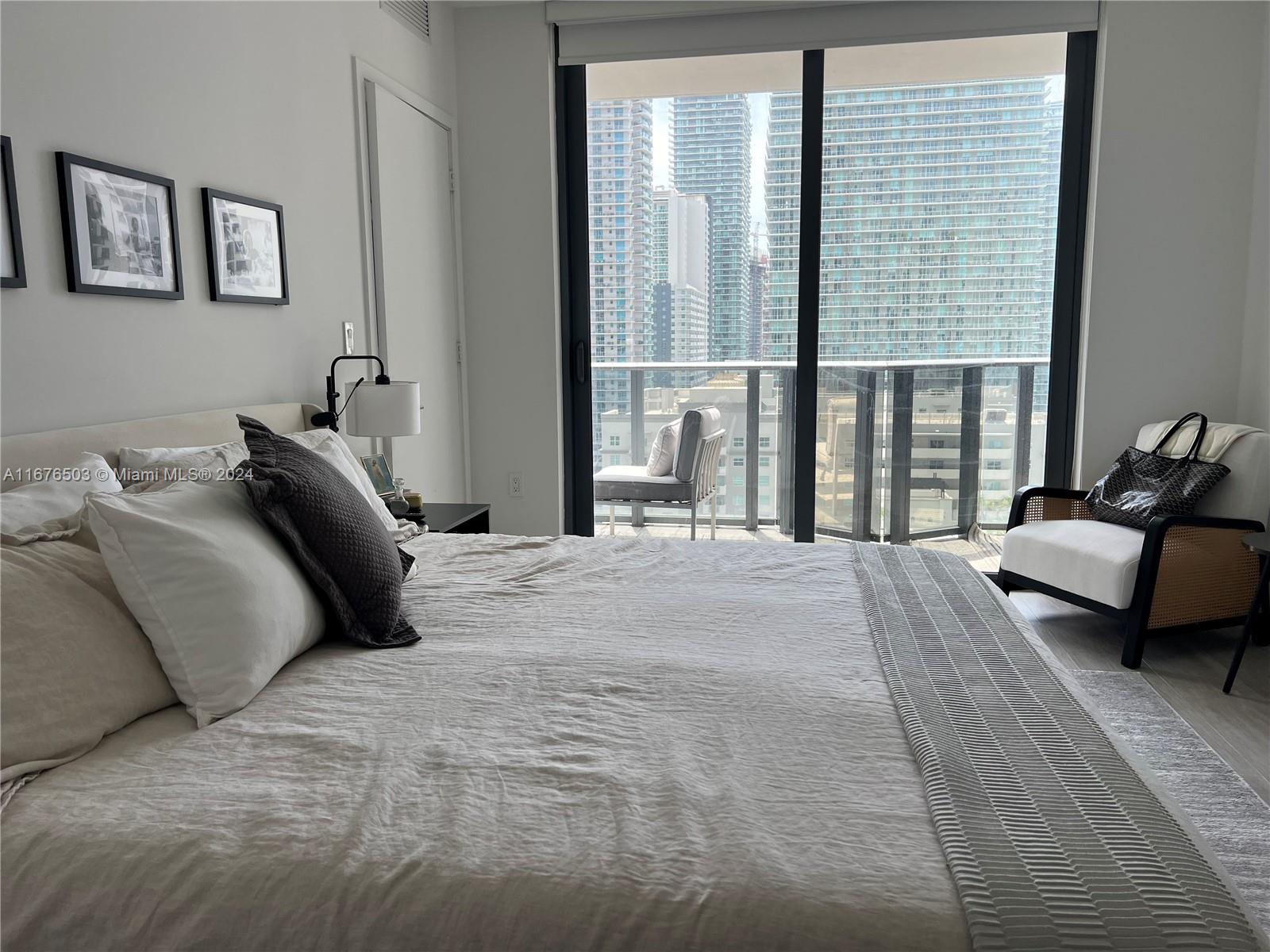 a bedroom with a bed and glass window