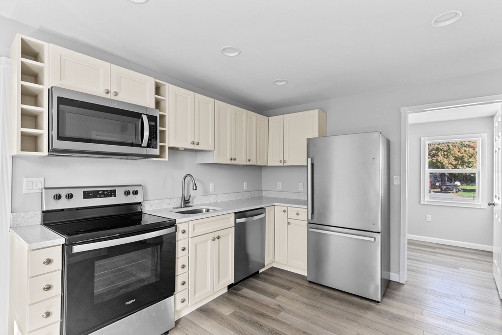 a kitchen with a refrigerator stove and microwave