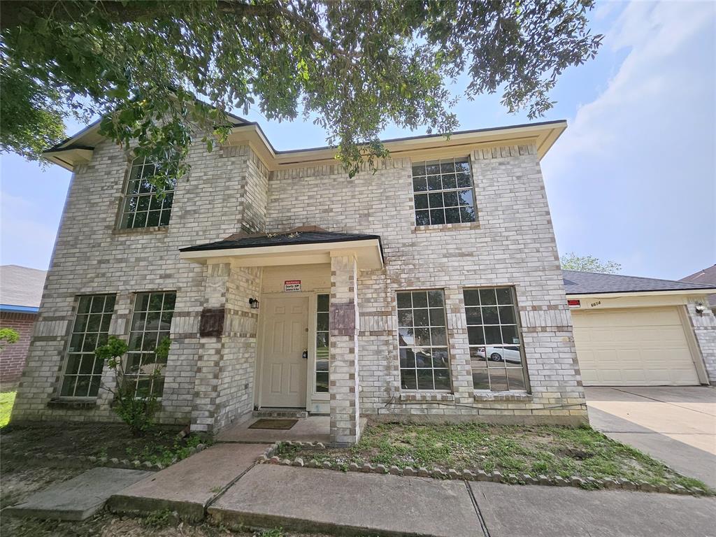 front view of a house with a tree