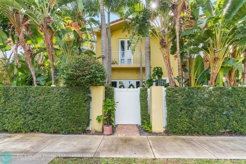 a view of a house with a plants and trees