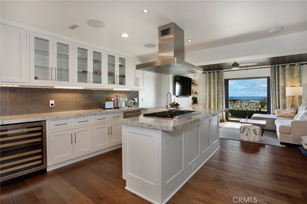 High-end island-style kitchen looking out towards ocean