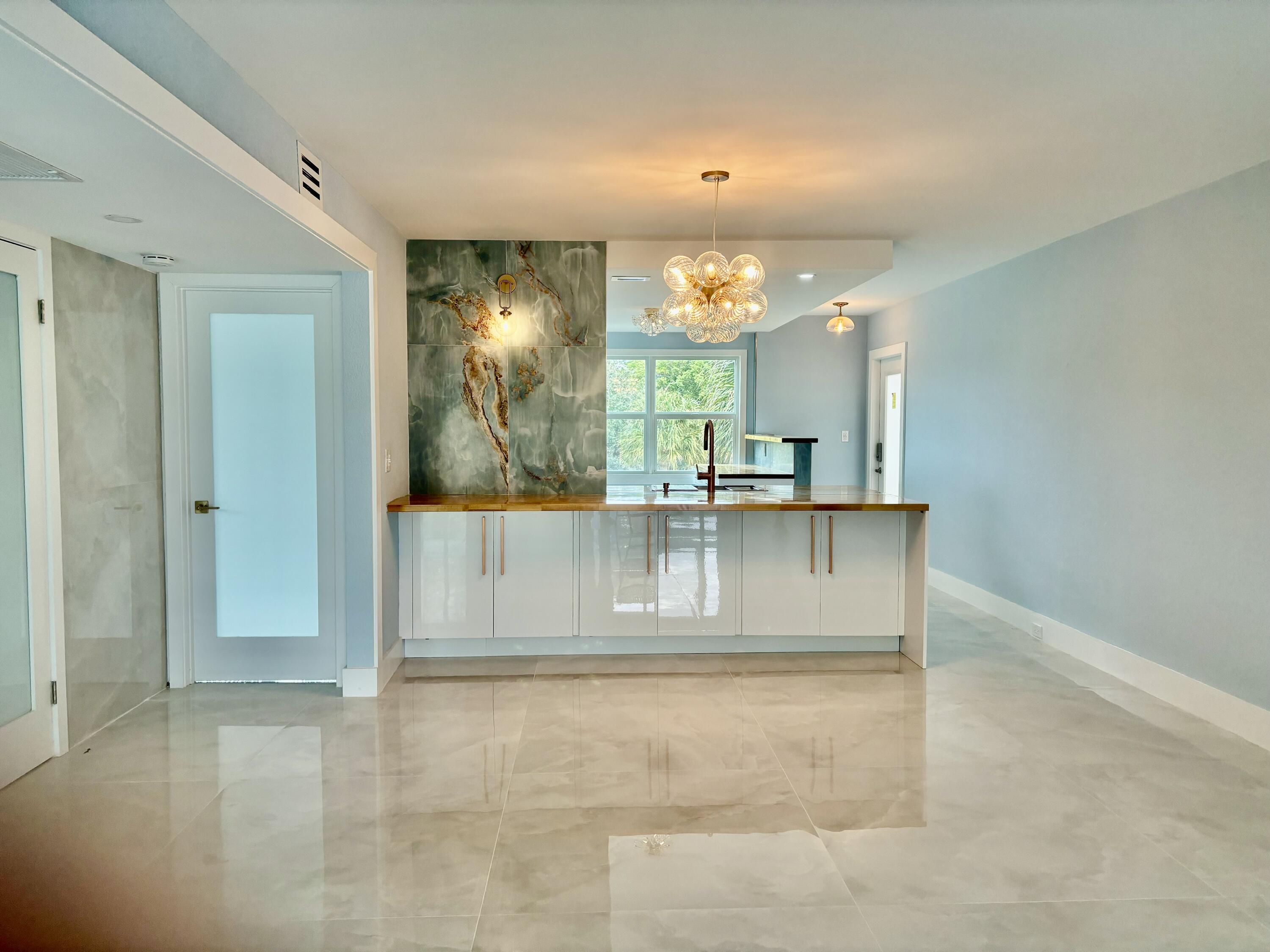 a view of kitchen with kitchen island dining table and chairs