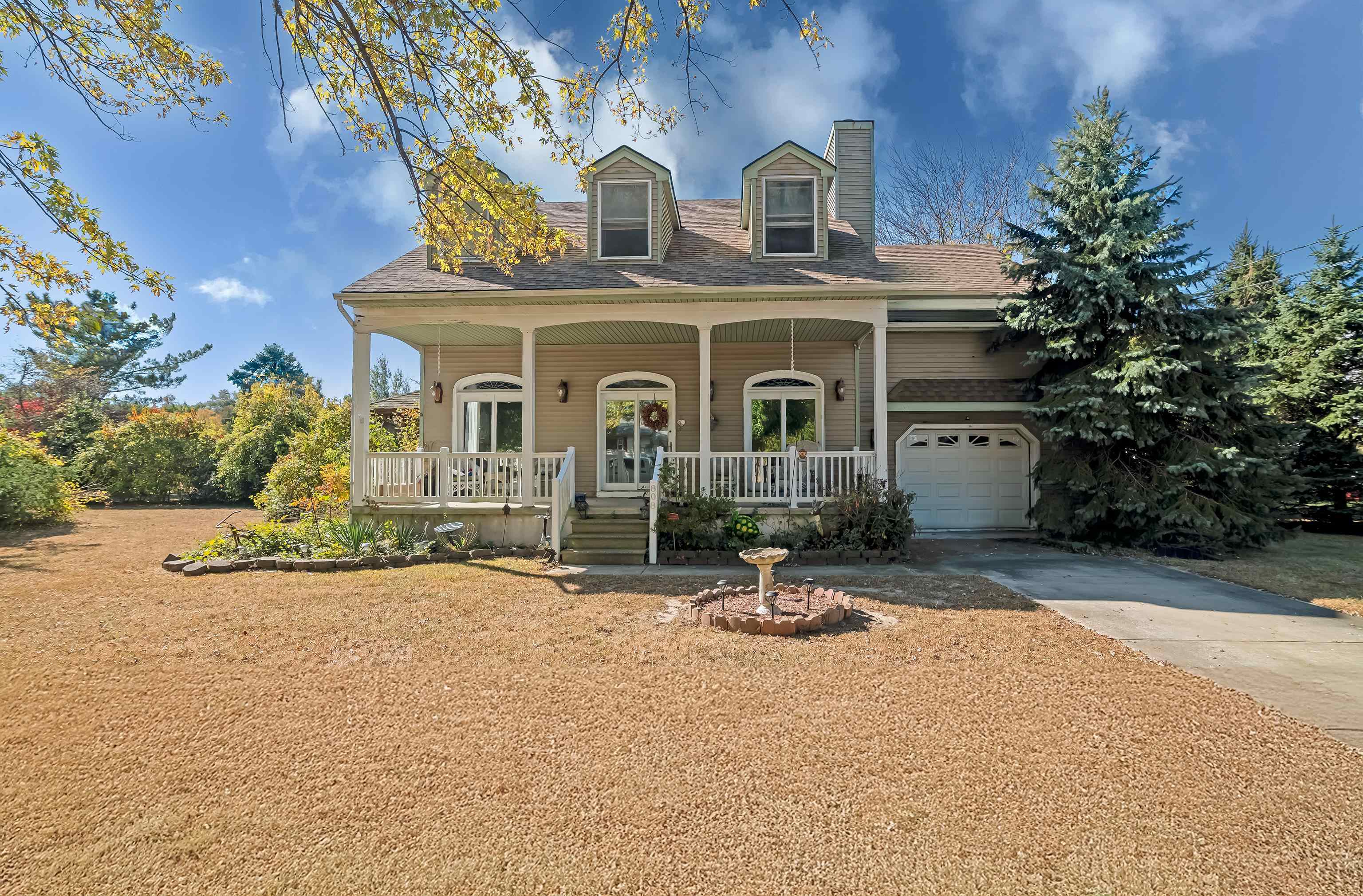 a view of house with outdoor space and sitting area