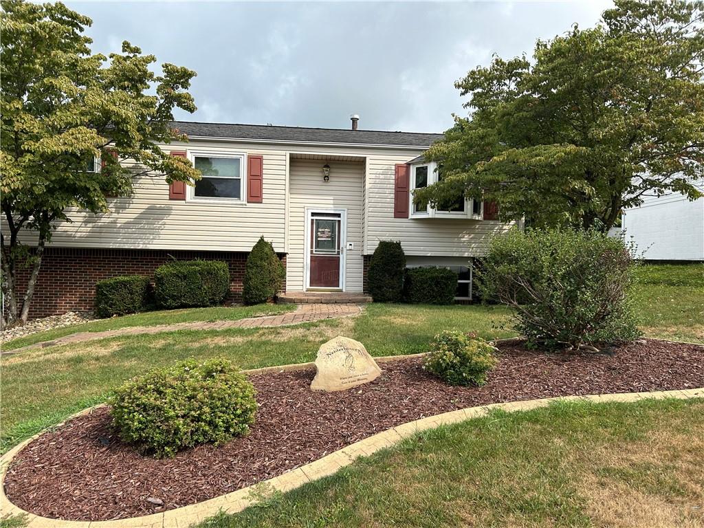 a front view of a house with a yard