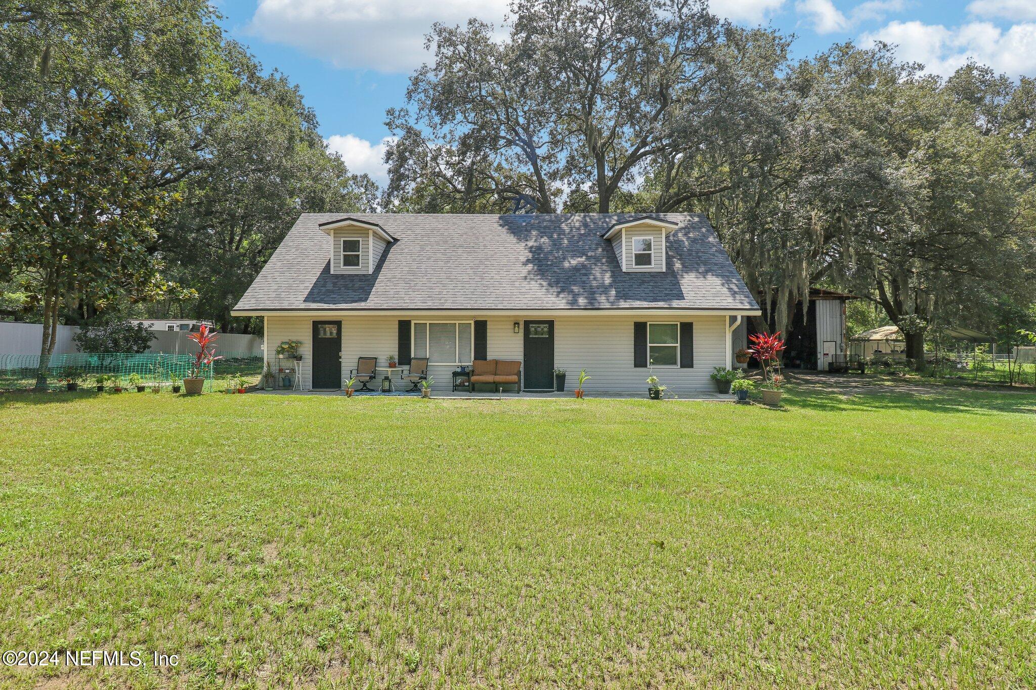 a front view of house with yard and green space