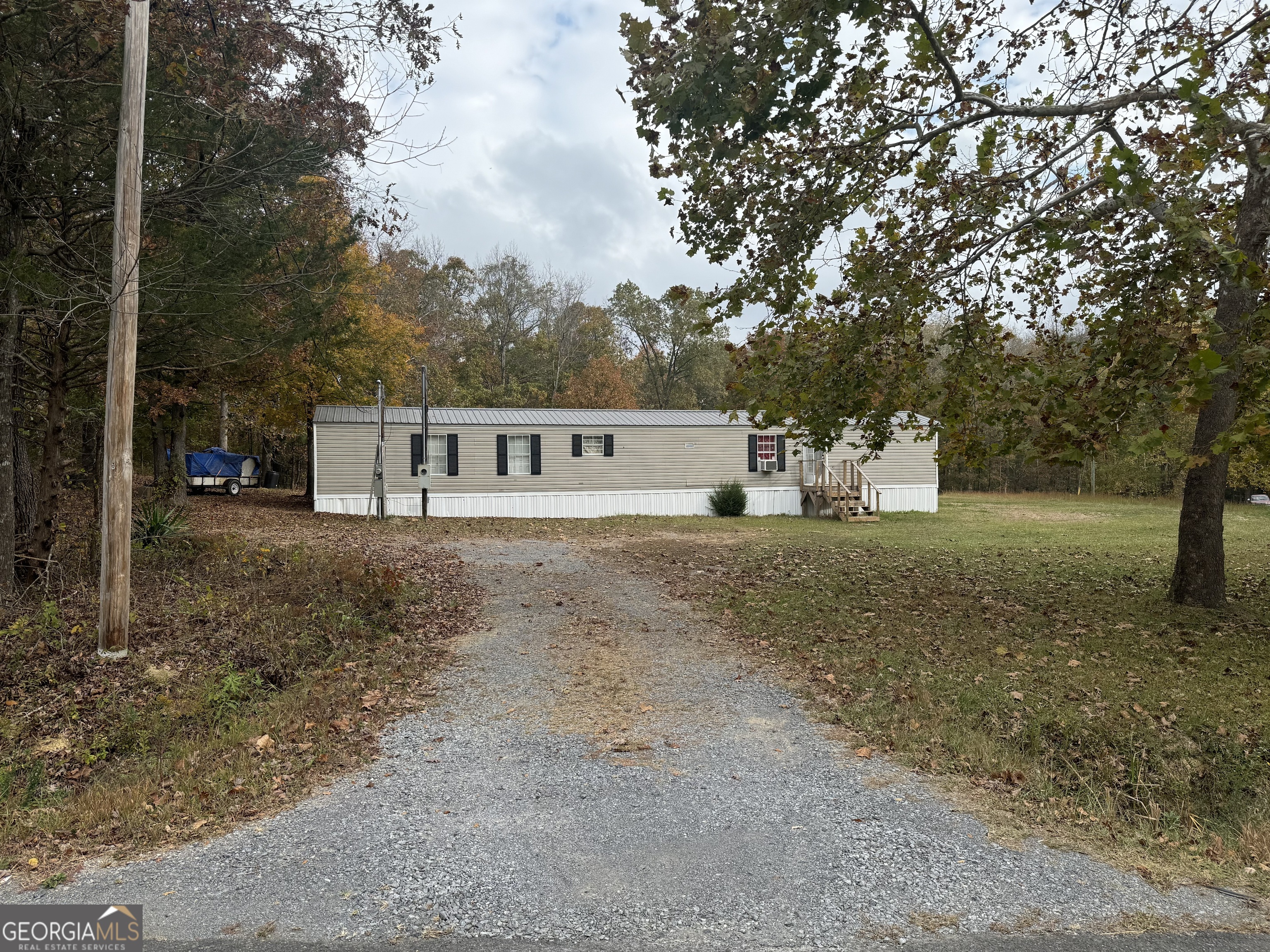 a view of house with a yard