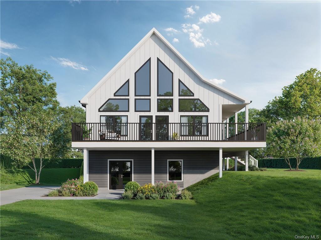 View of front facade featuring a deck and a front lawn