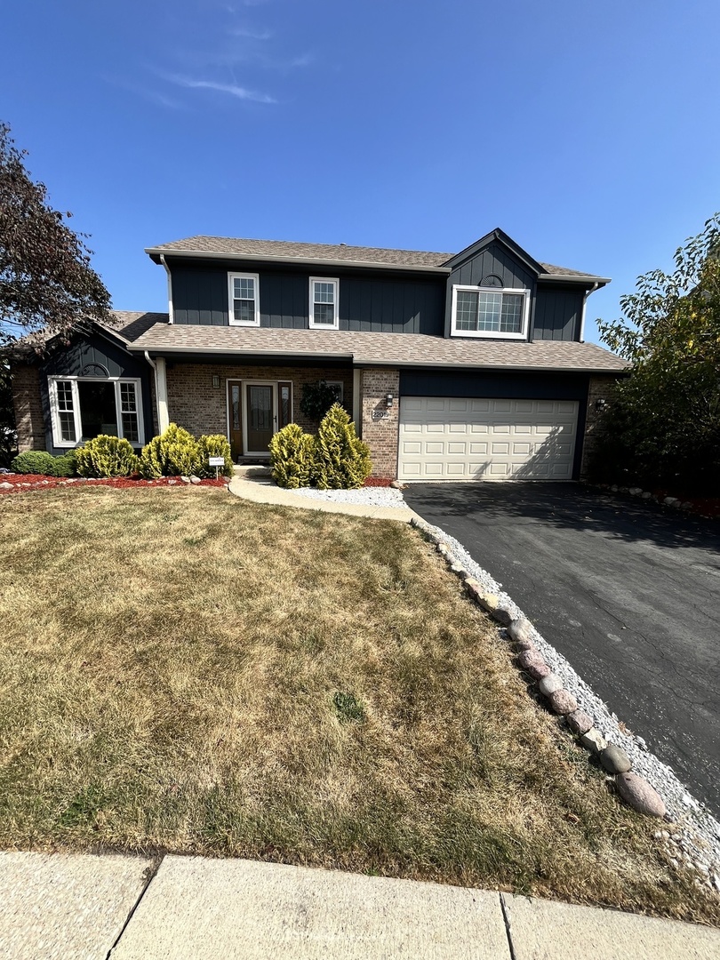 a front view of a house with a yard