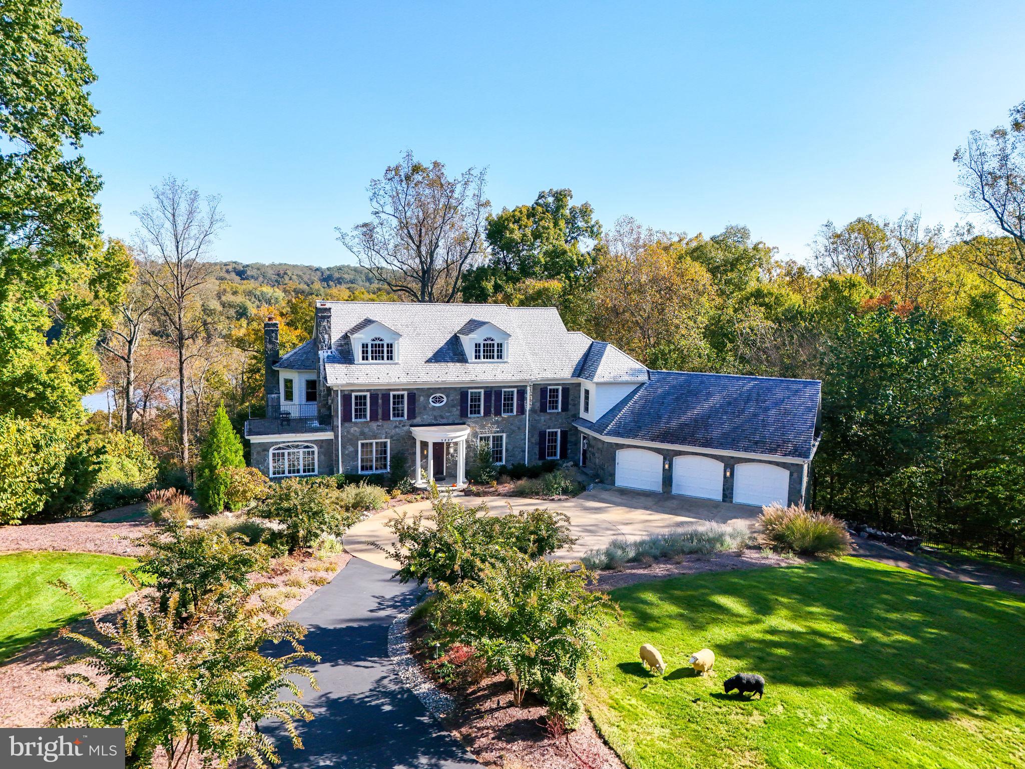 a view of a house with a big yard and large trees