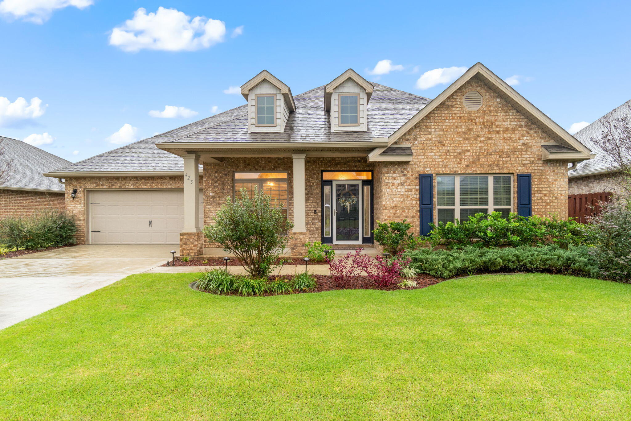 a front view of a house with a yard and garage