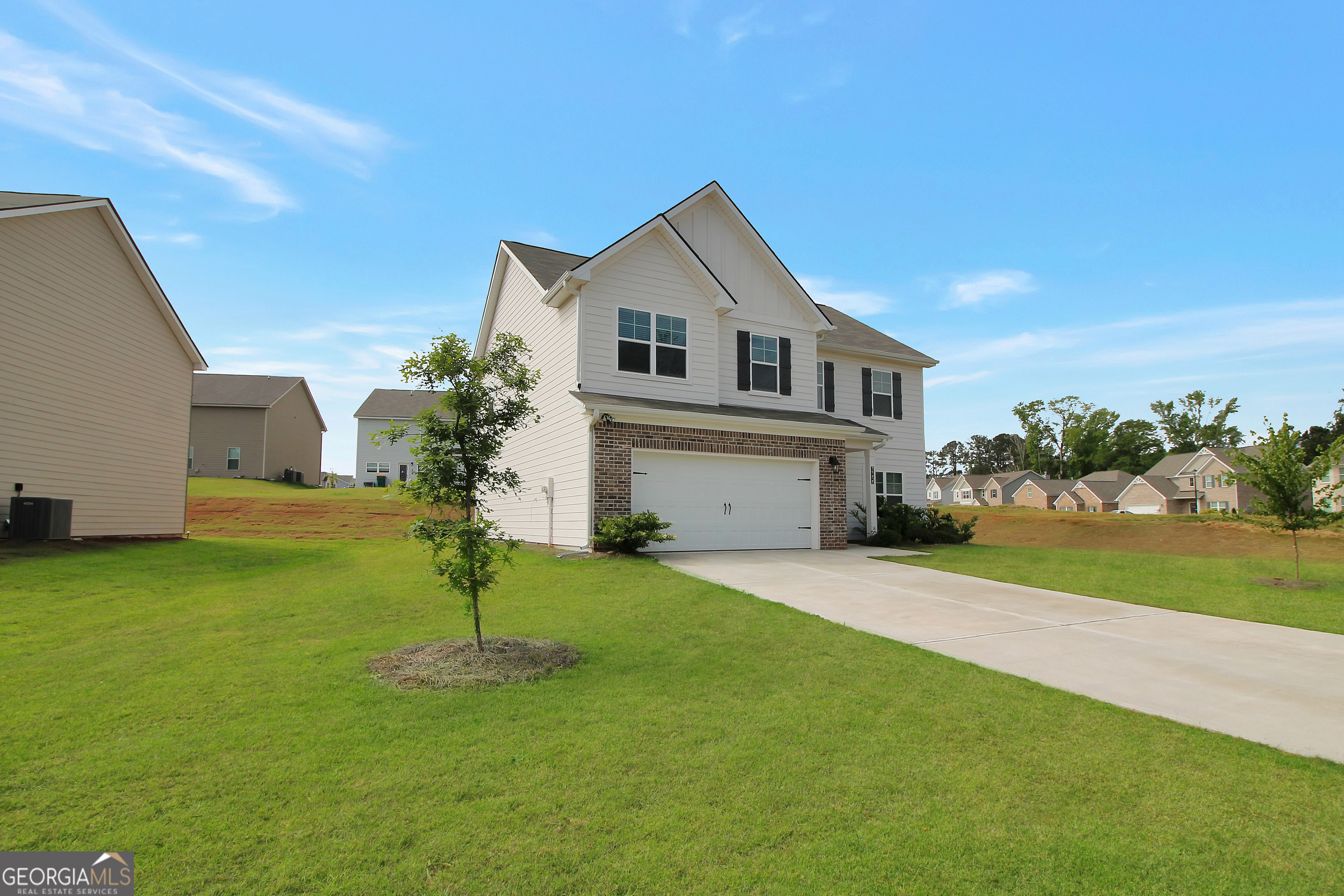 a front view of a house with a yard and garage