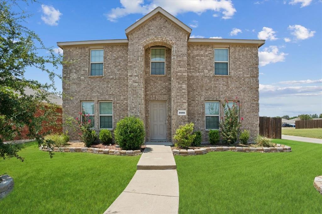 a front view of a house with a yard