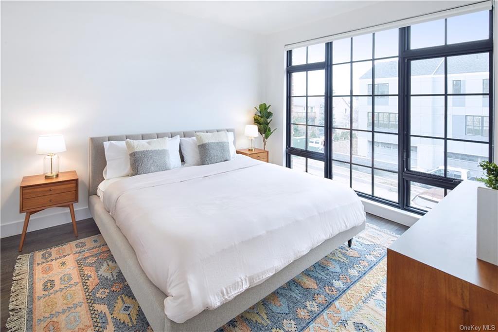 a large bed sitting in a bedroom next to a window