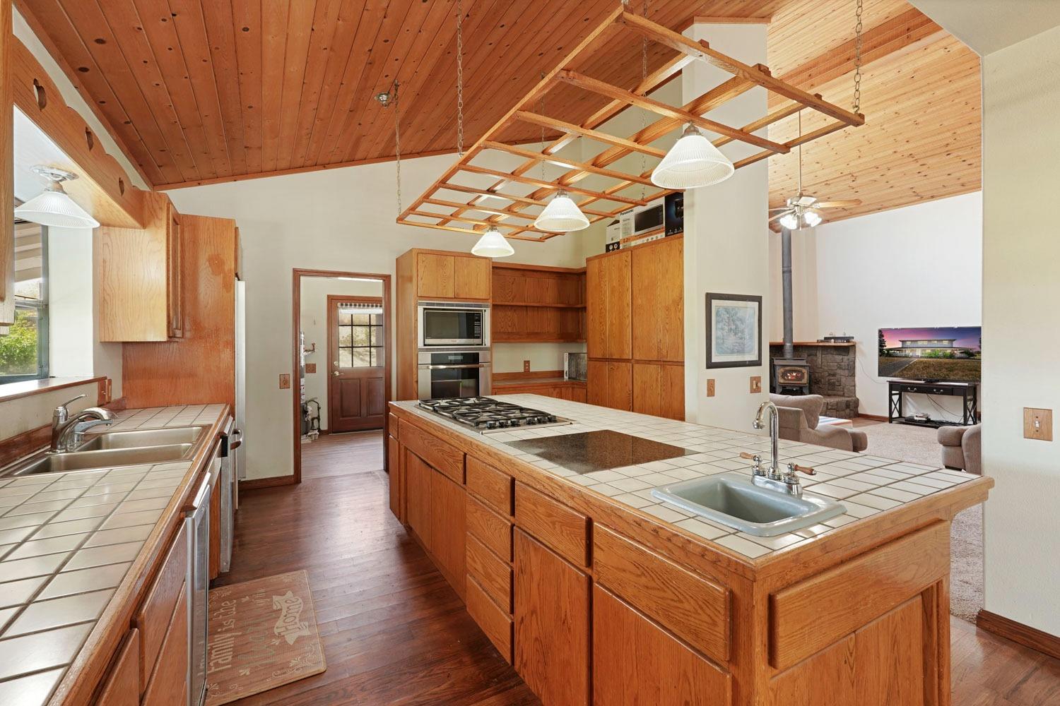 a kitchen with stainless steel appliances granite countertop a sink and a refrigerator