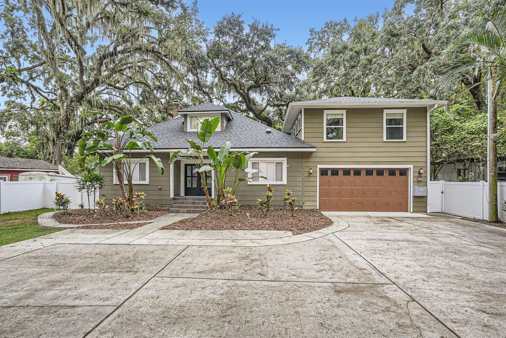 a view of a house with a patio and a yard