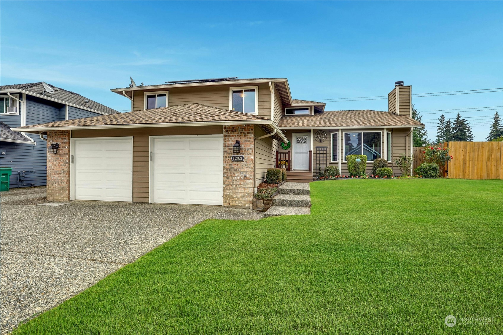 a front view of a house with a yard and garage